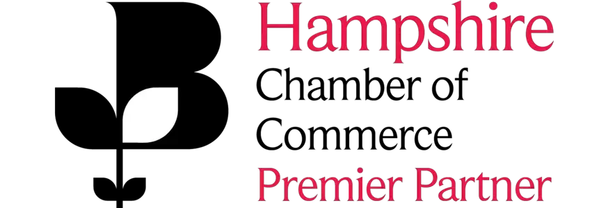 The Hampshire Chamber of Commerce logo with the text “Hampshire Chamber of Commerce Premier Partner” in black and red.